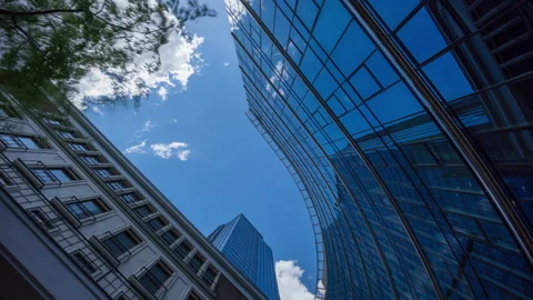 Wide angle looking up time-lapse financial district glass skyscrapers blue sky Stock Footage 337647490