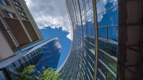 Wide angle looking up time-lapse financial district glass skyscrapers blue sky Stock Footage 337647495