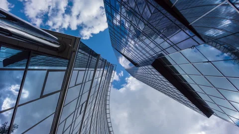 Wide angle looking up time-lapse financial district glass skyscrapers blue sky Stock Footage 337647555