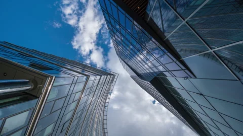 Wide angle looking up time-lapse financial district glass skyscrapers blue sky Stock Footage 337647581