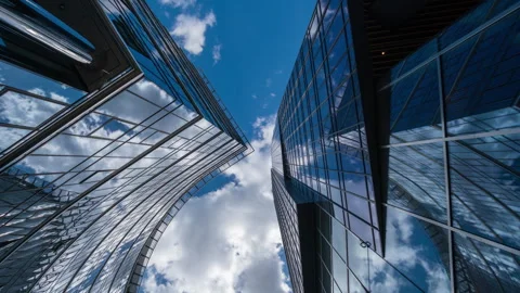 Wide angle looking up time-lapse financial district glass skyscrapers blue sky Stock Footage 337647588