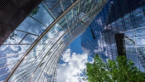 Wide angle looking up time-lapse financial district glass skyscrapers blue sky Stock Footage 337647590