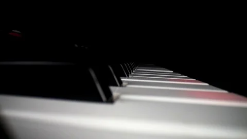 Wide angle macro of electronic keyboard - static shot of keyboard and song Stock Footage 127316410
