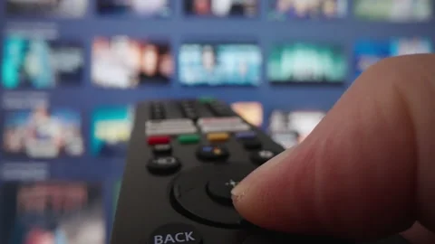 Wide angle macro shot of browsing content on smart TV using remote control Stock Footage 218650671