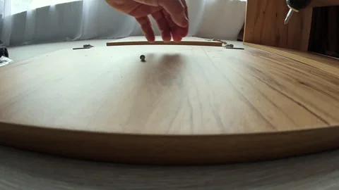 Wide angle of Man assembling kitchen wooden elements of new cabinet with Video stock 309323618