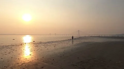 Wide Angle Man Walking In front of Bandra Worli Sea Link, Mumbai, India Stock Footage 146004673