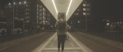 Wide Angle Man Walking In The Station Waiting The Tram Neon Light Stock-Footage 154790031