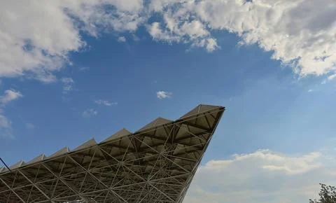 Wide angle of a modern complex architecture made of metal against blue sky Stock Photos