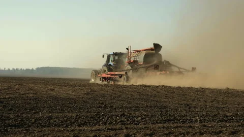 Wide Angle of Modern Tractor Towing Precision Air Seeder Sowing Crops Stock Footage 305261252