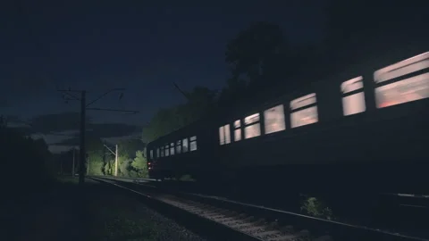 Wide-Angle Night Train Passing on Railway Track | Illuminated Passenger Carriage Stock Footage 343452490