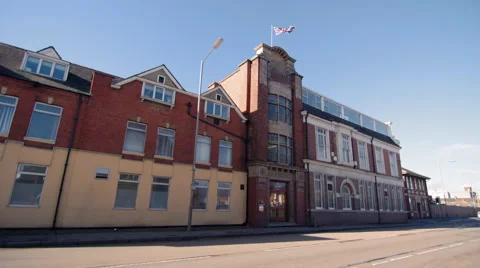 Wide Angle of Old Shop Front as Traffic Passes Stock Footage 61640217