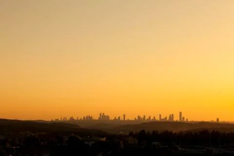 Wide angle orange sunset scene with many skyscrapers and city center forest visi Stock Photos