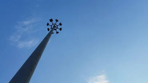 Wide Angle Orbiting Shot of High Mast Lighting Pole Against Clear Blue Sky Stock Footage 340183495