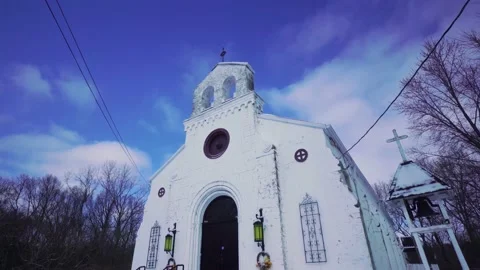 Wide angle pan of old stone church revealing heavy freshly fallen snow Stock Footage 148677050