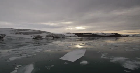 Wide Angle Pan Setting Sun over Icy Bay Stock Footage 56741842