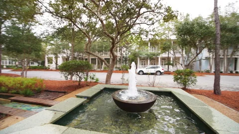 Wide angle panning of Seaside Florida Cerulean green park water fountain canal Stock Footage 161847089
