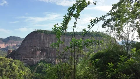 Wide angle panning shot of dramatic sandstone cliffs rising Stock Footage 339638323