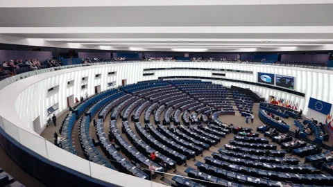 Wide angle panning shot inside European Parliament hemicycle during active Stock Footage 318065123