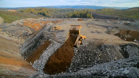 Wide angle panorama Yellow dump truck unloads rocks and gravel Stock Footage 122073818