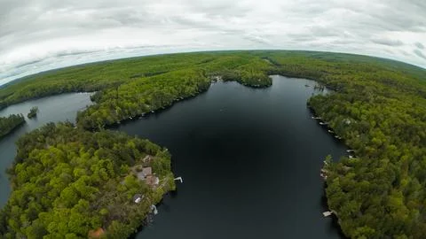 Wide angle panoramic drone perspective overlooking an expansive northern lake Foto stock