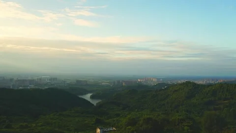 Wide angle panoramic view of green mountains and city skyline at sunset Stock-Footage 347039358