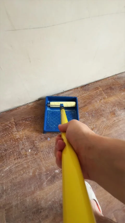 Wide angle perspective of applying primer to ceiling with pole roller Stock Footage 340405005
