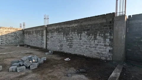 Wide angle perspective capturing a newly constructed perimeter retaining wall Stock Footage 337869598