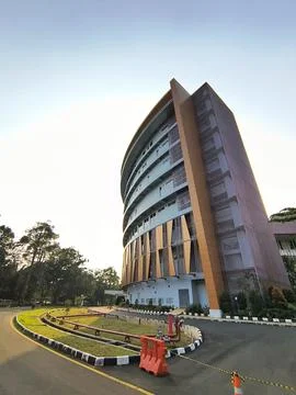 Wide angle perspective of a modern curved building and driveway. Stock Photos