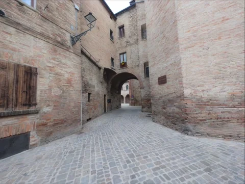 A wide-angle perspective of a narrow medieval Italian alleyway Stock Footage 344154471