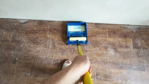 Wide angle perspective of priming ceiling with roller on extension pole Stock Footage 340404006
