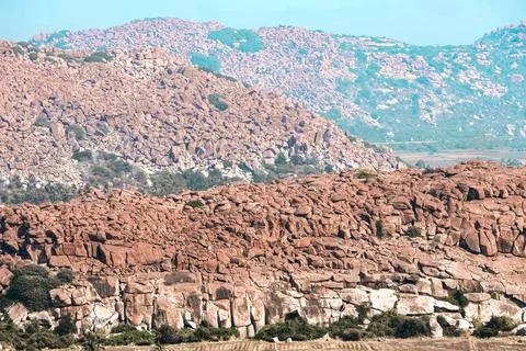Wide-angle photo captures the dramatic boulder-strewn landscape of Hampi Stock Photos
