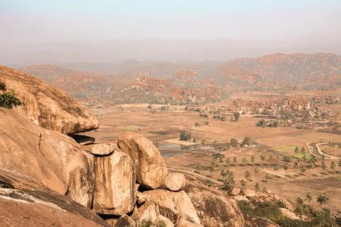 Wide-angle photo captures the dramatic boulder-strewn landscape of Hampi Stock Photos
