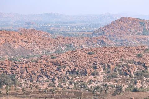 Wide-angle photo captures the dramatic boulder-strewn landscape of Hampi Stock Photos