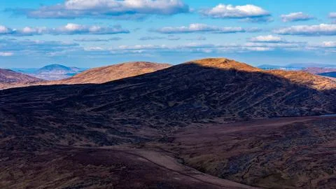 The wide-angle photograph displays a sequence of mountain chains Stock Photos