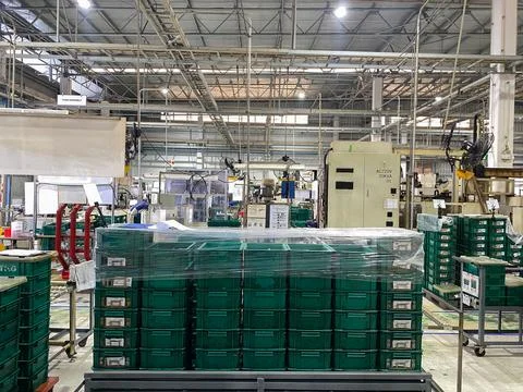 Wide-angle photograph of plastic storage bins arranged across a manufacturing Stock Photos