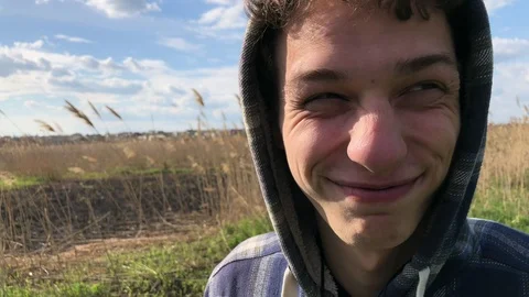 Wide angle portrait of young guy making funny face and aping on the natural Stockbeeldmateriaal 106636906