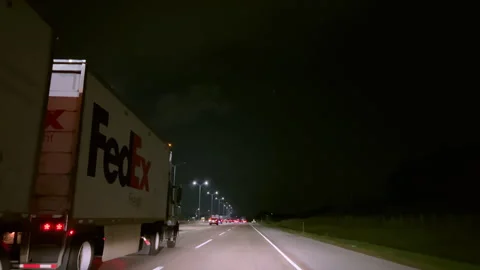 Wide Angle POV Driving view. A FEDEX Truck delivers parcels, highway night time Stock-Footage 251662700