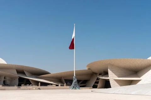 Wide angle of Qatari flag at National Museum of Qatar with copy space Foto stock