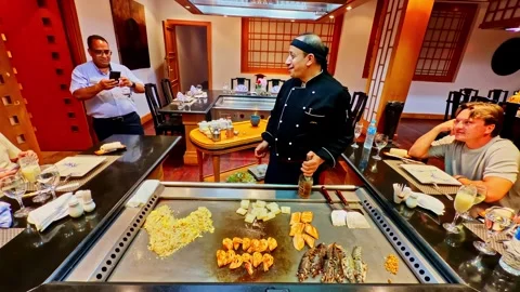 Wide angle restaurant establishing master chef showman playing with fire Stock Footage 332586103