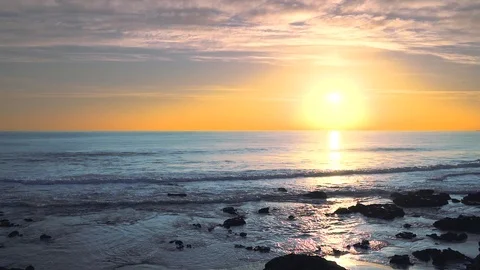 Wide angle seascape view looking straight into the sun at sunset, 動画素材 108934393