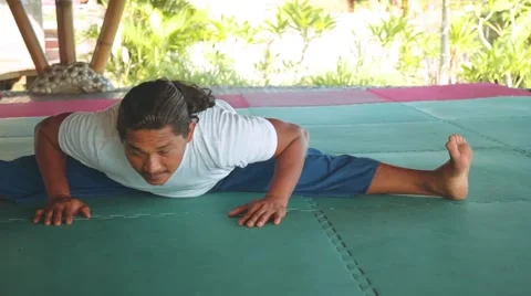 Wide-Angle Seated Forward Bend, Upavistha Konasana by balinese man doing yoga Stock Footage 68084767