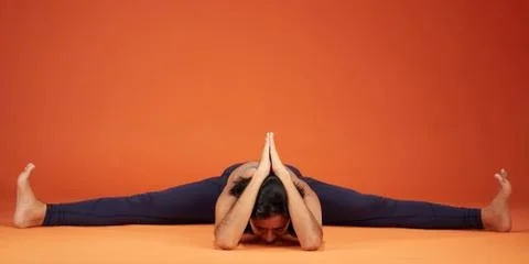 Wide Angle Seated Forward Bend yoga pose Stock Photos