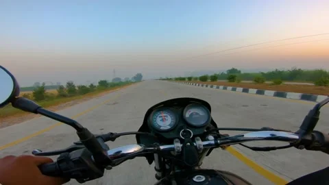 A wide angle Shoot on a motorcyclist Riding Видео 146149623