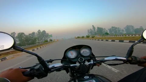 A wide angle Shoot on a motorcyclist Riding Vídeos de archivo 146149944