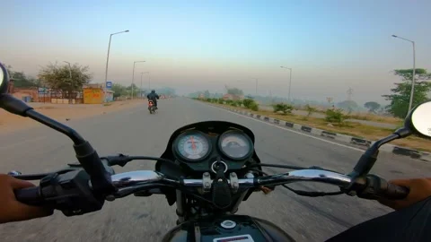 A wide angle Shoot on a motorcyclist Riding Stock Footage 146150145