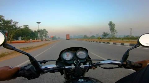 A wide angle Shoot on a motorcyclist Riding Stockbeeldmateriaal 146150295