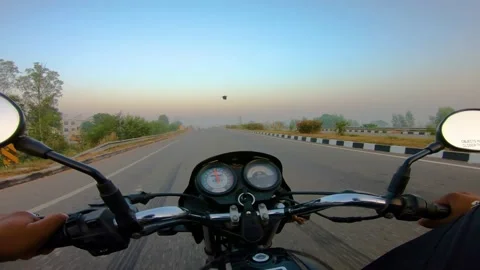 A wide angle Shoot on a motorcyclist Riding Vídeos de archivo 146150455
