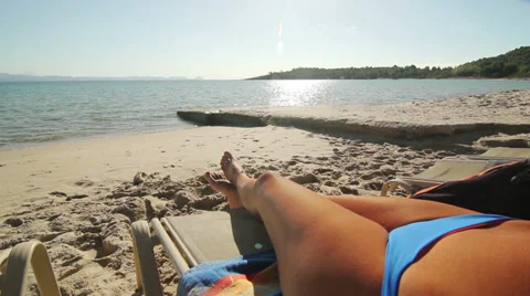 Wide angle shot of an attractive young woman tanning Stock Footage 33666015