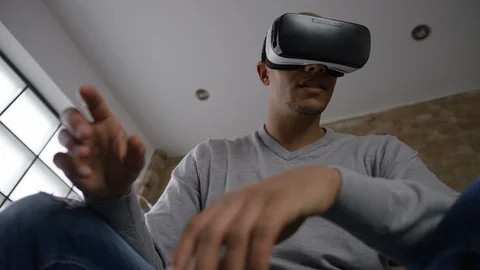 Wide angle shot from below of a man using a virtual reality headset Video stock 96290227