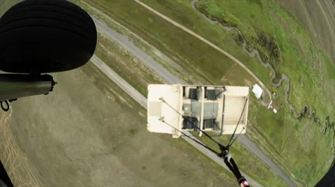 Wide angle shot of Black Hawk helicopter hauling Humvee. Stock Footage 52701727